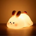 Cute rabbit-shaped night light on a dark background
